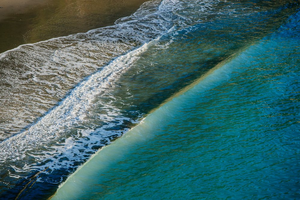 Ocean wave rolling onto the sandy beach, Boardman State Park, Oregon, USA.