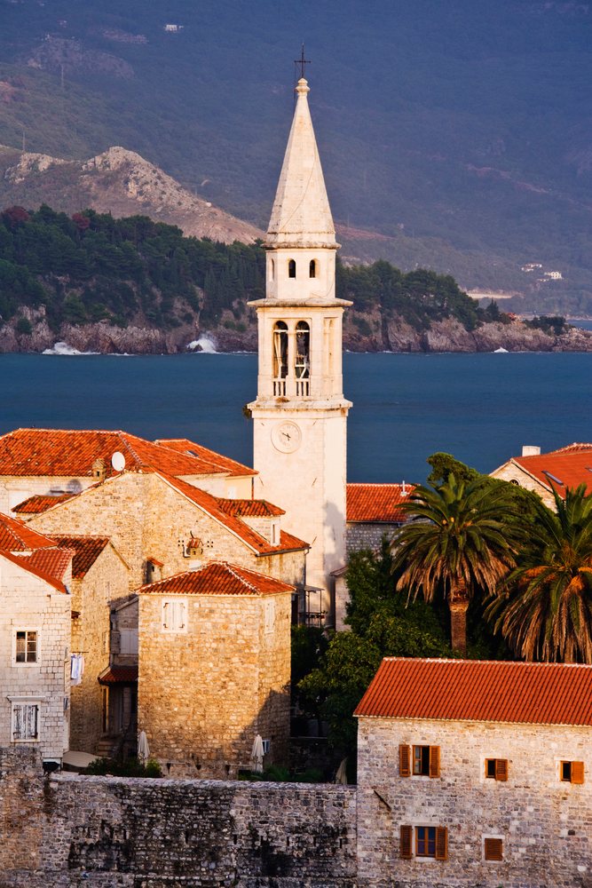 Church tower and red roofs seaside town montenegro.