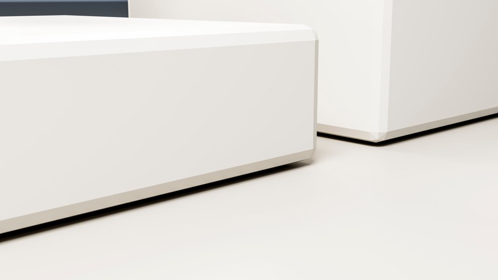 Close-up of white rectangular boxes with clean surfaces and sharp edges against a light background with shadow beneath.