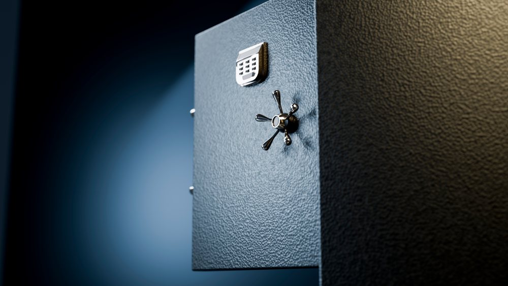 Metal safe with a textured surface, security lock handle, and keypad on a blue background.