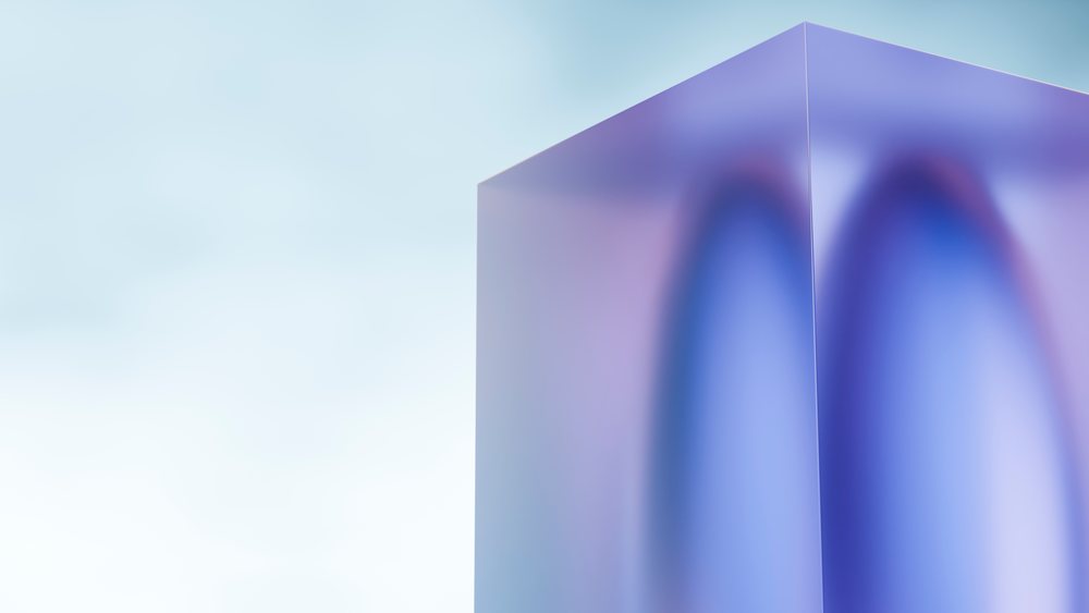 Blue and purple reflective geometric cube with smooth surfaces positioned against a soft gradient background.