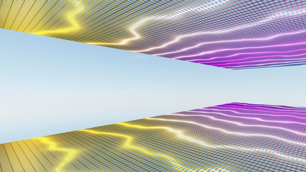 Digital screens displaying colorful neon lights and grid patterns reflecting against a clear blue sky background.