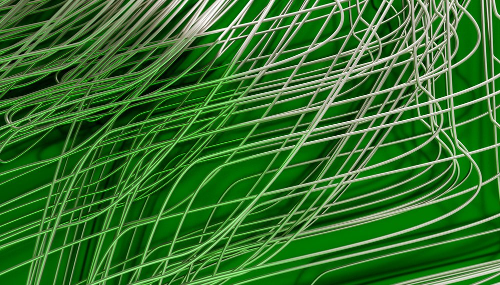 Wire sculpture featuring curved metal wires on a green background in a studio setting.
