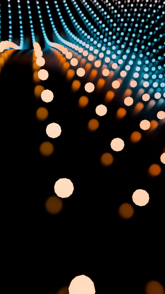 Blue and orange glowing LED lights form an abstract curved pattern on a dark background, creating an illumination effect.