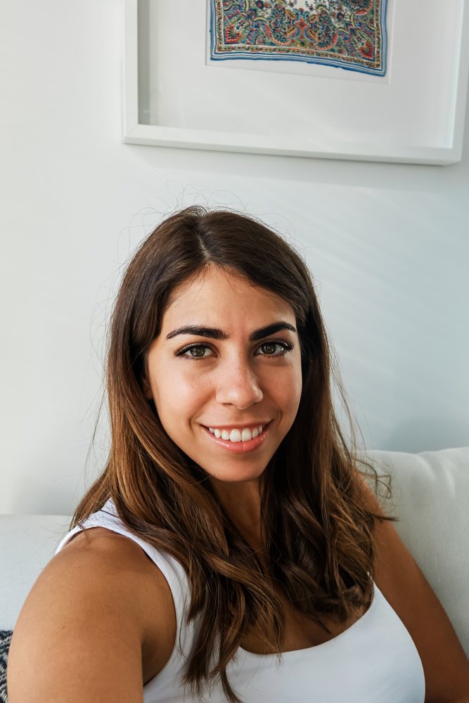 A young white woman smiling inside a modern icelandic home