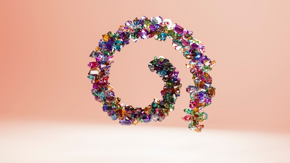 Spiral-shaped at symbol formed by colorful transparent crystals floating against a pink background in a digital 3D illustration.