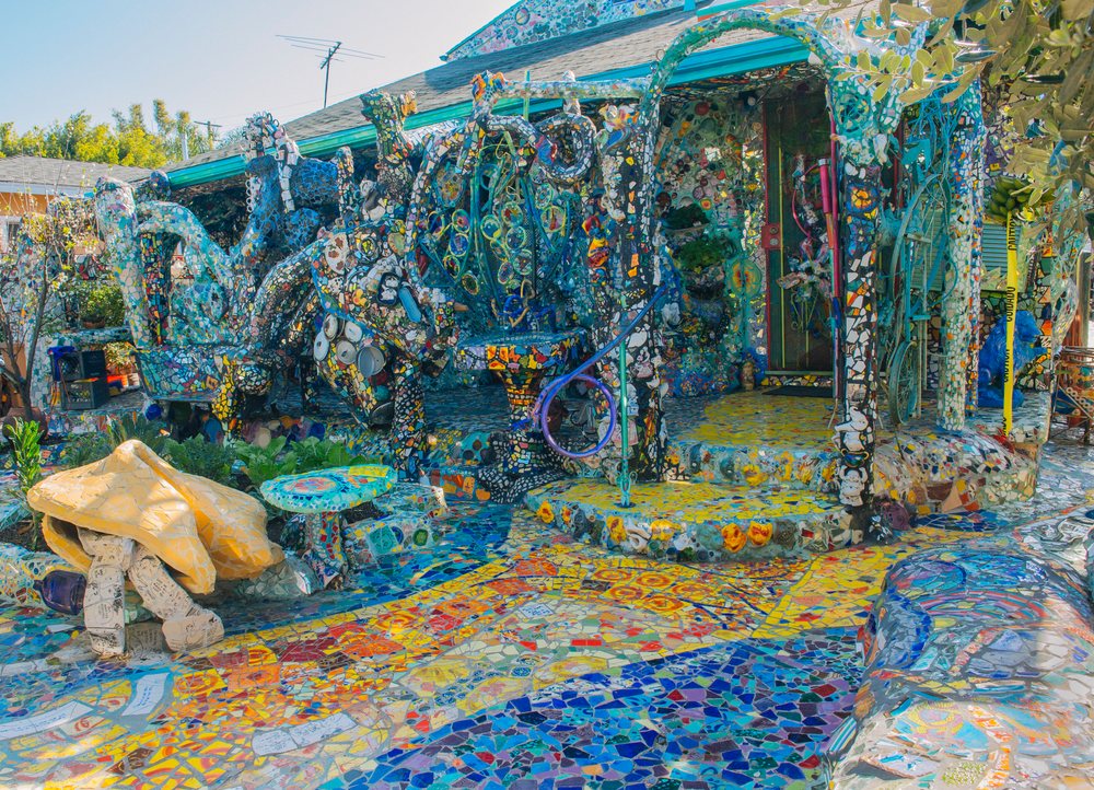 House facade and garden in lifornia feature colorful mosaic tiles and decorative ceramic sculptures in an outdoor artistic installation, CA, USA.