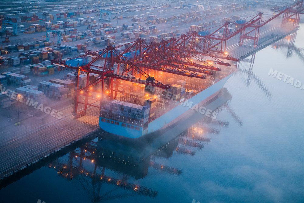 Large container ship unloading cargo at port terminal in Long Beach