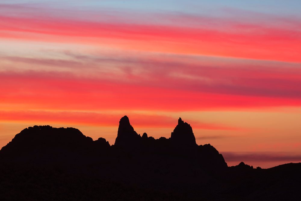 Silhouette of Mule Ears rock formations at Sunrise over Big Bend National Park, landscape, wildlife, Texas, USA.
