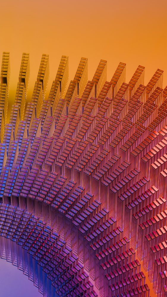 Stacked translucent rectangular glass blocks arranged in a symmetrical geometric pattern with orange to purple color gradients.