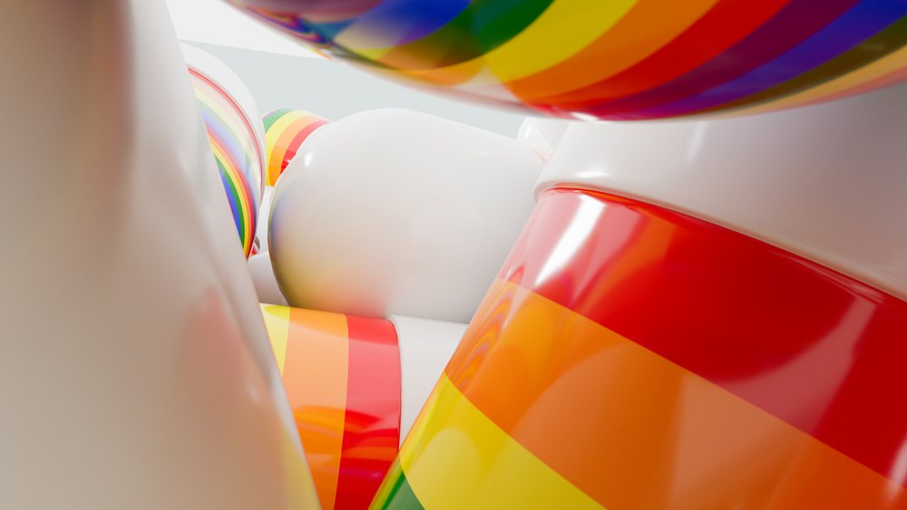 Close-up view of shiny plastic balls with rainbow stripes and smooth white surfaces arranged in an abstract colorful composition.