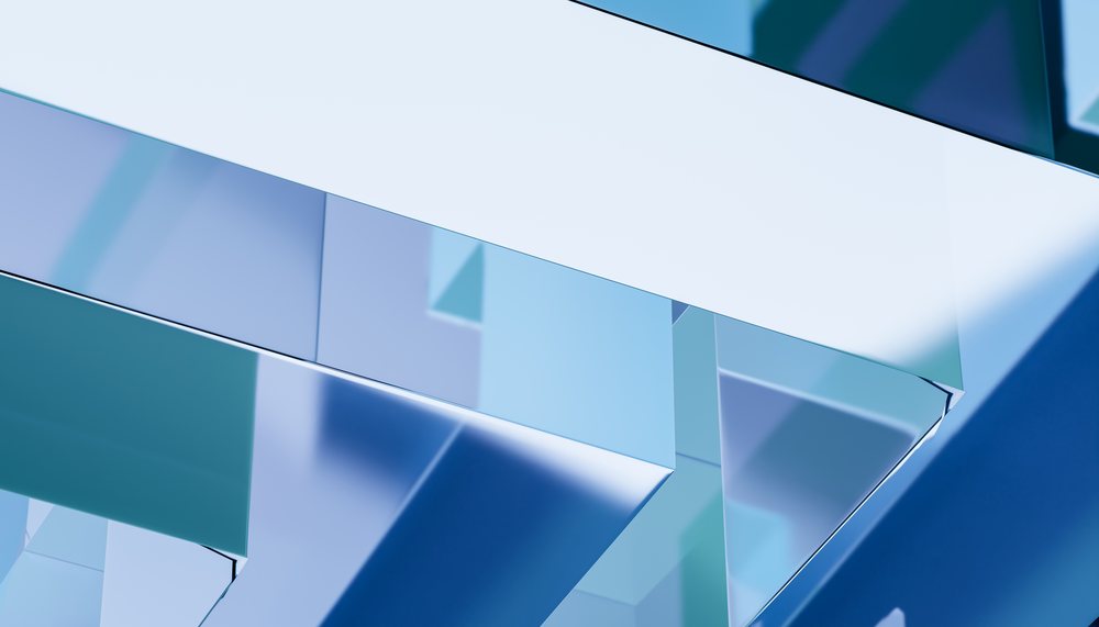 Abstract digital render shows geometric glass-like shapes with blue reflections and smooth surfaces in a modern design.