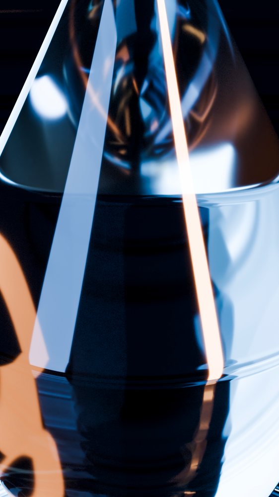 Close-up of a glass container showing abstract light reflections in translucent blue and orange hues.