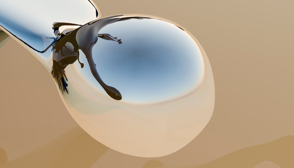 Close-up image of a milk splash on a reflective metal spoon