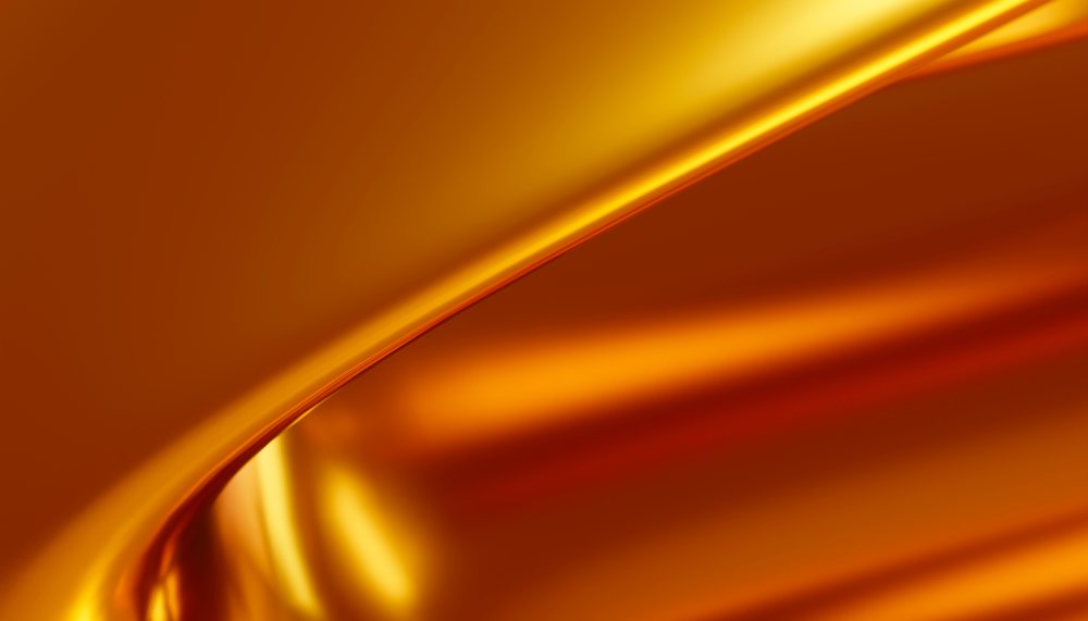 Gold metallic surface featuring smooth reflective curves with warm orange highlights.