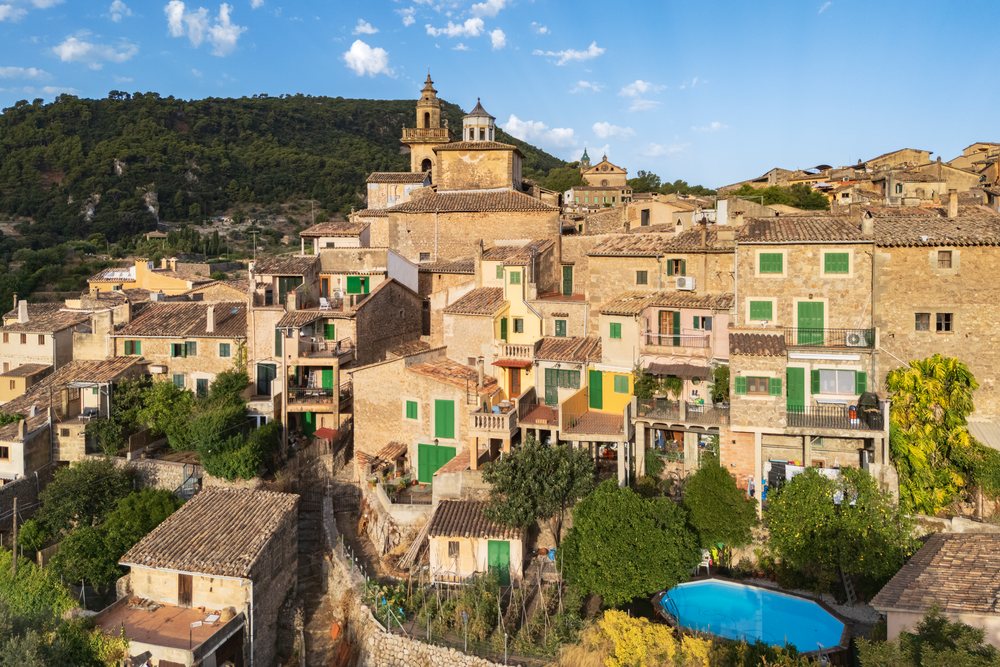 Stone buildings with green shutters and a swimming pool in Valdemossa town at Sunrise, Landscape, Lifestyle, Mallorca, Spain.