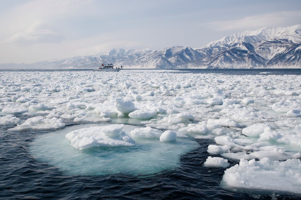 Ship navigates through floating pack ice in a sea, Hokkaido, Japan.