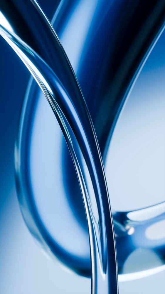 Closeup of curved transparent blue glass tubes with smooth reflective surfaces forming an abstract composition.