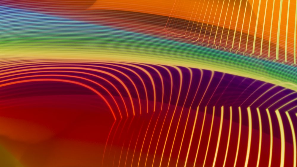 Abstract digital illustration featuring colorful curved lines forming a bright rainbow gradient pattern.