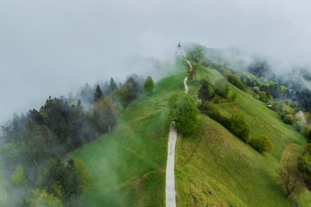 Church of Primus and Felician atop a misty hill, Landscape, Jamnik, Slovenia.