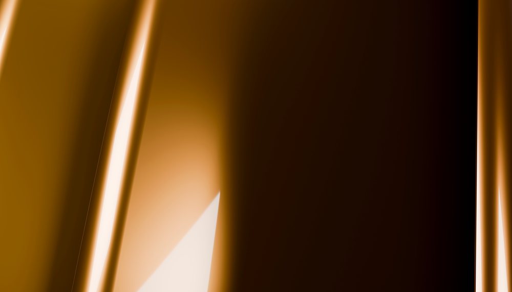 Closeup of a smooth, glossy brown chocolate block with a reflective surface and rich texture.