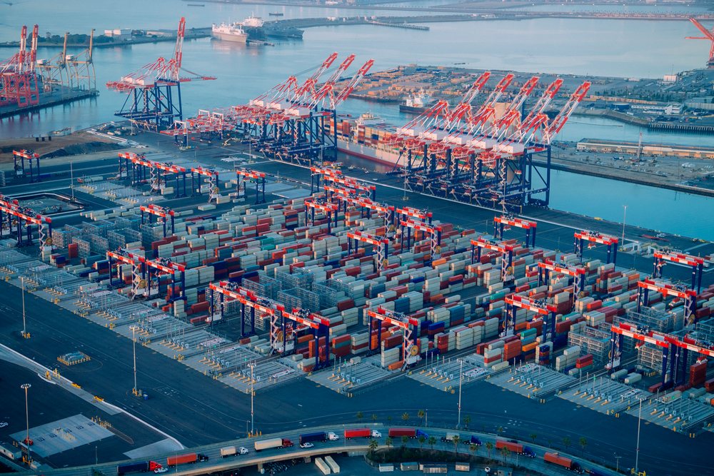 Container terminal with cranes and stacked shipping containers by the water at an industrial port in Long Beach, industrial port in Long Beach, CA, CA, USA.