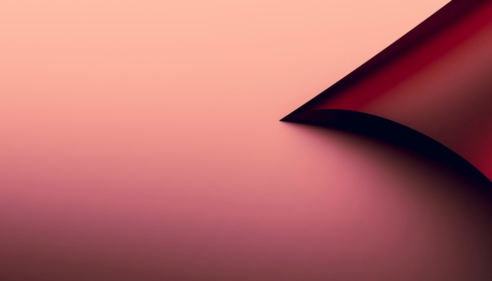 A close-up of a curled paper corner casting a shadow on a soft pink gradient background.