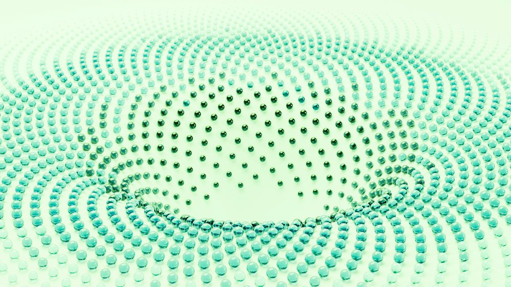 3D digital illustration of blue spherical beads arranged in a spiral wave pattern on a green background.