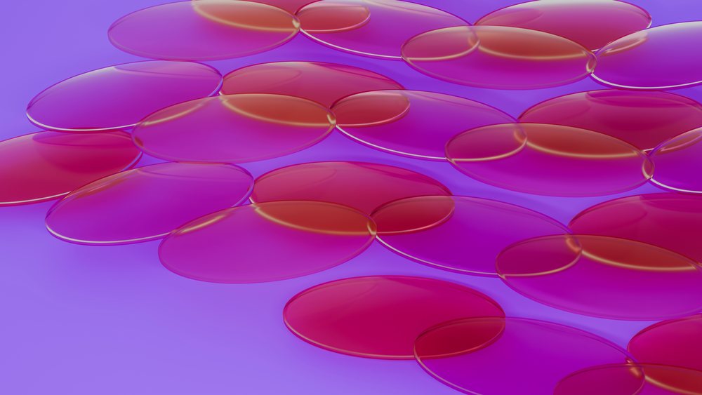 Microscopic close-up showing translucent, round red blood cells clustered together in a fluid environment.