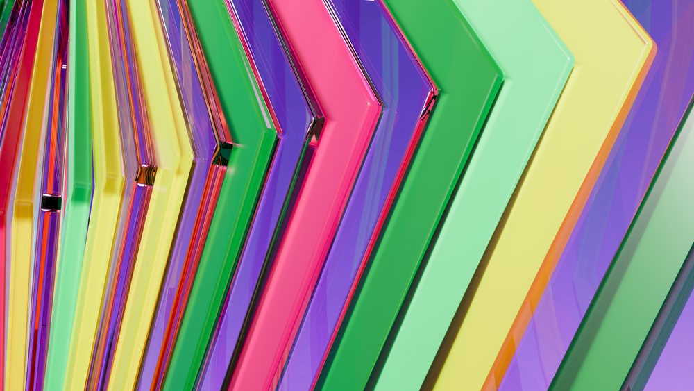 Multiple translucent arrows in bright pink, green, yellow, and purple arranged diagonally in a shiny abstract geometric pattern.