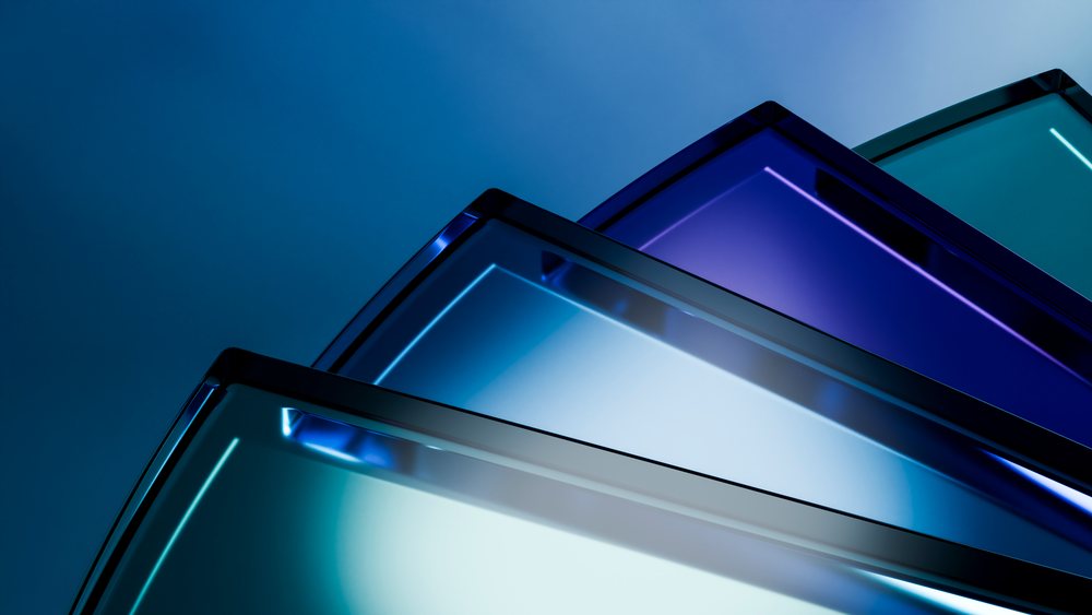 Angled blue tinted glass panels with reflective surfaces and geometric shapes form a modern design composition.