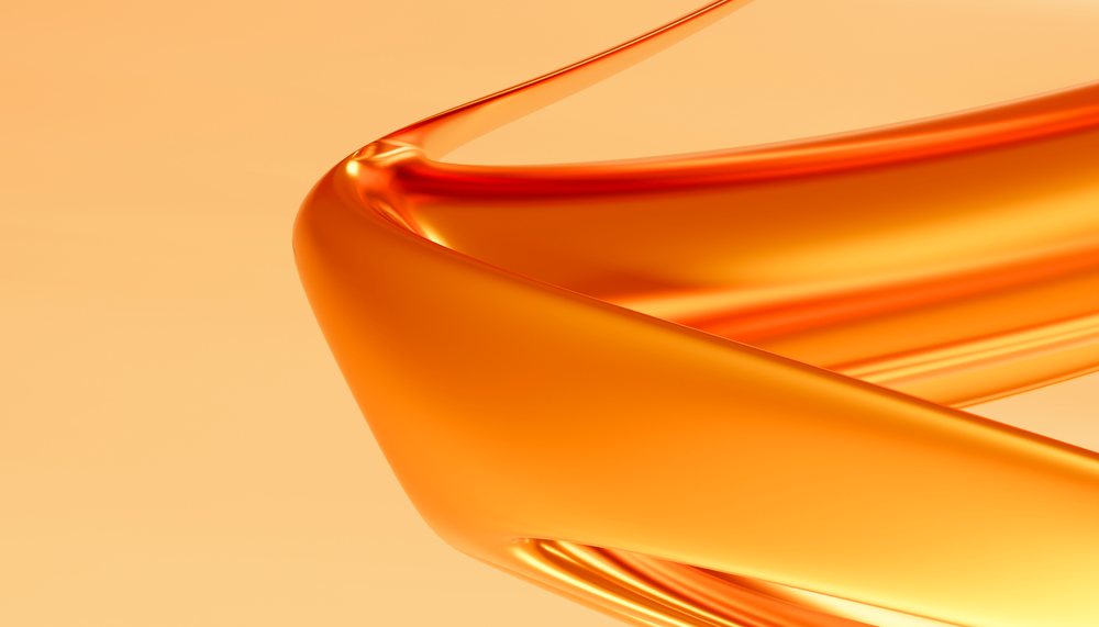 Abstract close-up of a smooth, curved orange ribbon with glossy texture on an orange background.
