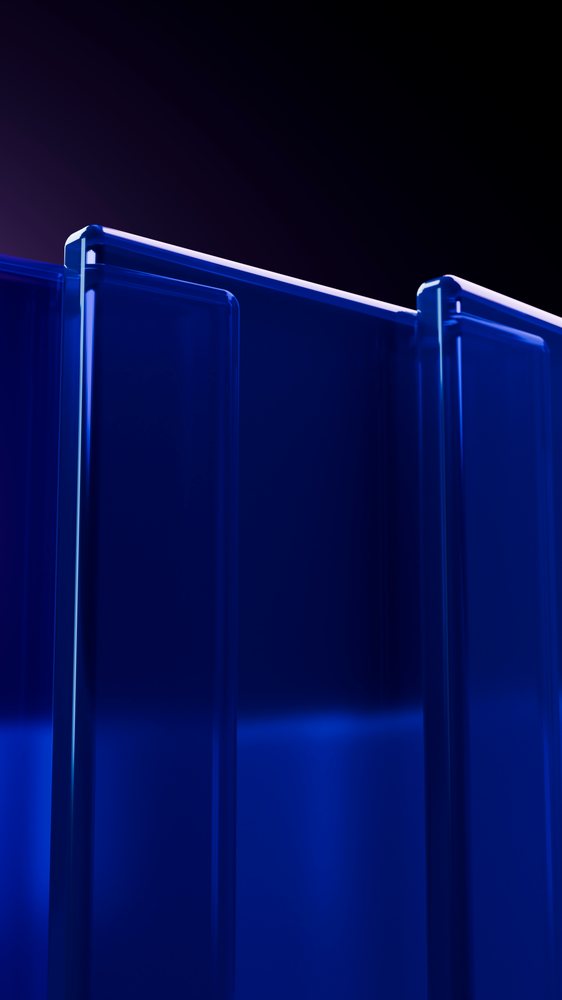 Blue transparent vertical glass panels with illuminated edges arranged in a modern abstract studio design.