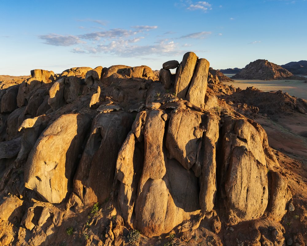 Balanced rock formation illuminated by sunrise light, landscape, wildlife, The bear at Rock Gardens, Kunene Region, Namibia.