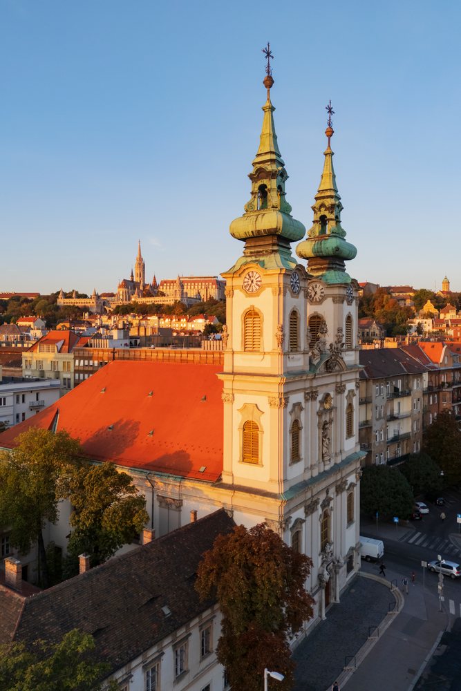 Baroque Church of St Anne in Batthyány Square, with twin towers and copper-green onion domes at sunset, Landscape, Budapest, Hungary.