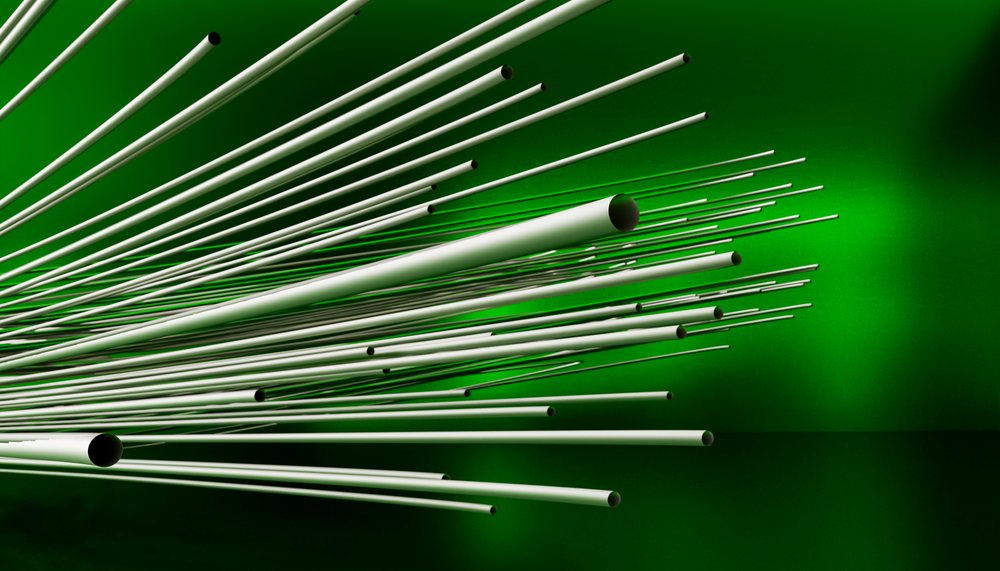 White tubes form a geometric abstract pattern against a vibrant green background in a modern artistic composition.