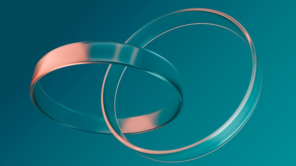 Two interlocked transparent rings with smooth reflective surfaces float against a solid teal background in a digital 3D illustration.