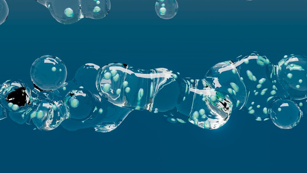 Transparent bubbles containing small green spheres float against a blue background in a 3D scientific illustration.