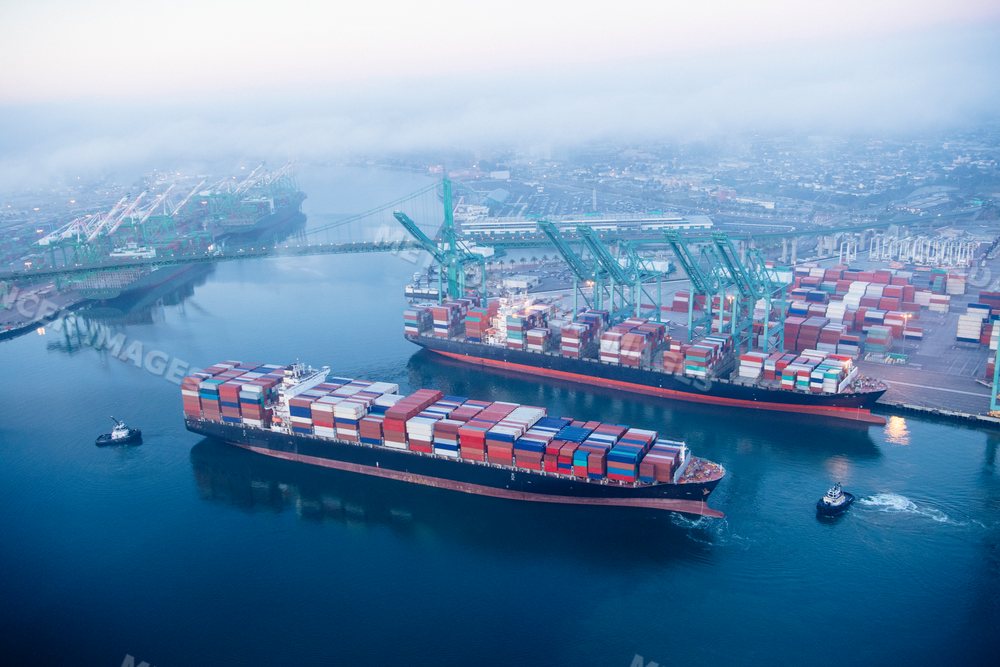 Aerial view of container ships at a busy port in a beach