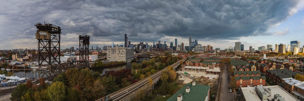 Canal Street Railway Bridge spans river with Chicago skyline and storm clouds in the background, Americana, Historic, Illinois, USA.