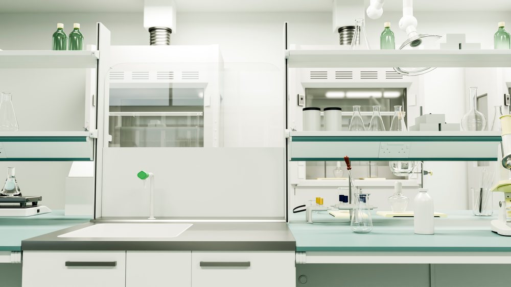 Clean laboratory workspace with scientific glassware, microscope, test tubes, and equipment arranged on a laboratory bench.