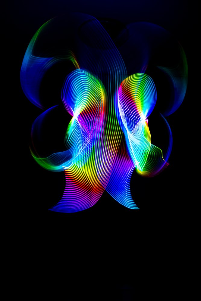 Colorful abstract light painting created with LED lights on a dark background showing vibrant patterns and motion captured by long exposure photography.