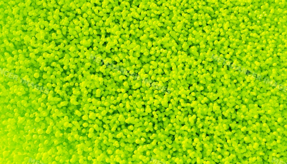 Close-up of a vibrant pile of small yellow balls forming a textured