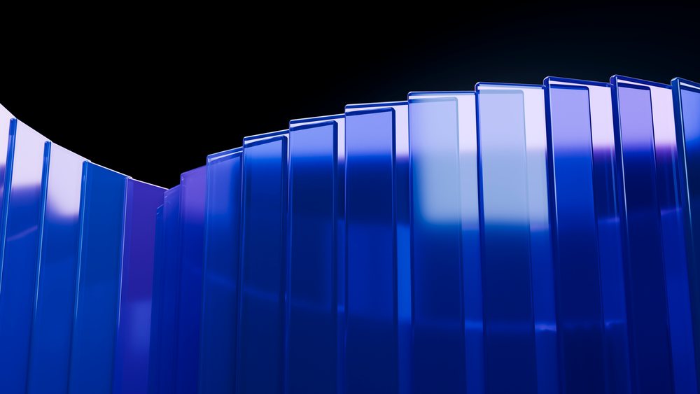 Multiple vertically aligned blue transparent glass panels curve to form a reflective modern architectural design against a black background.