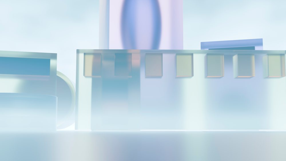 Translucent abstract glass geometric shapes with soft pastel colors and reflections in a minimal studio setting.