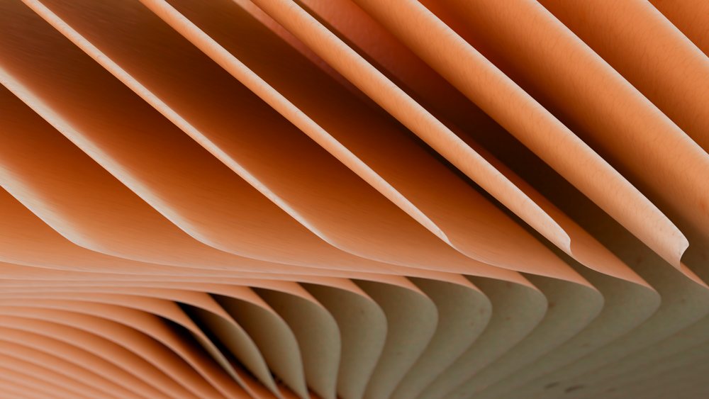 Close-up showing folded pages and curved paper edges in an open book with visible texture and volume.