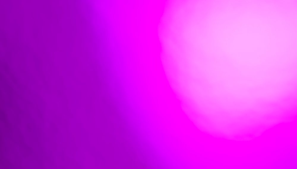 Abstract vibrant pink and purple light gradient background with soft glowing effect.