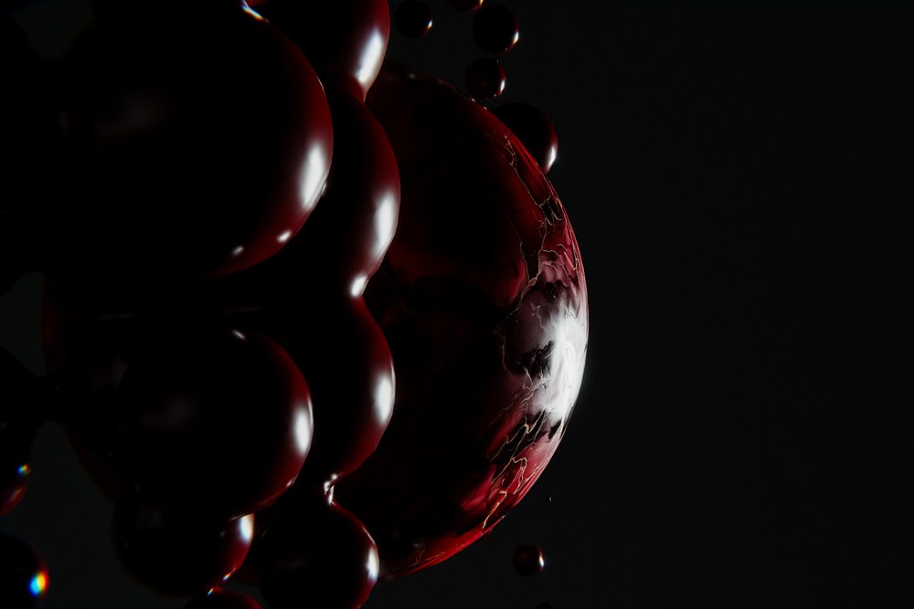 Glossy red spheres with marbled textures clustered on a black background showing reflections in a digital abstract composition.