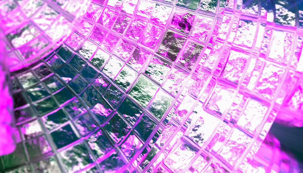 Close-up view of textured glass blocks with pink lighting creating abstract patterns.