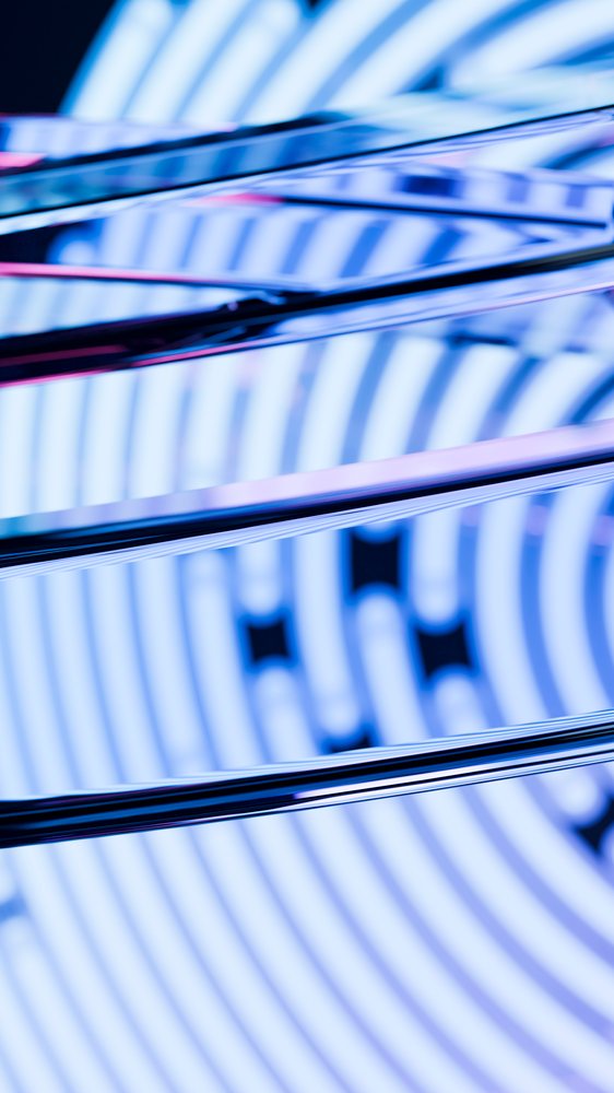 Close-up of reflective metal rods against a blue circular patterned background in an abstract modern design.